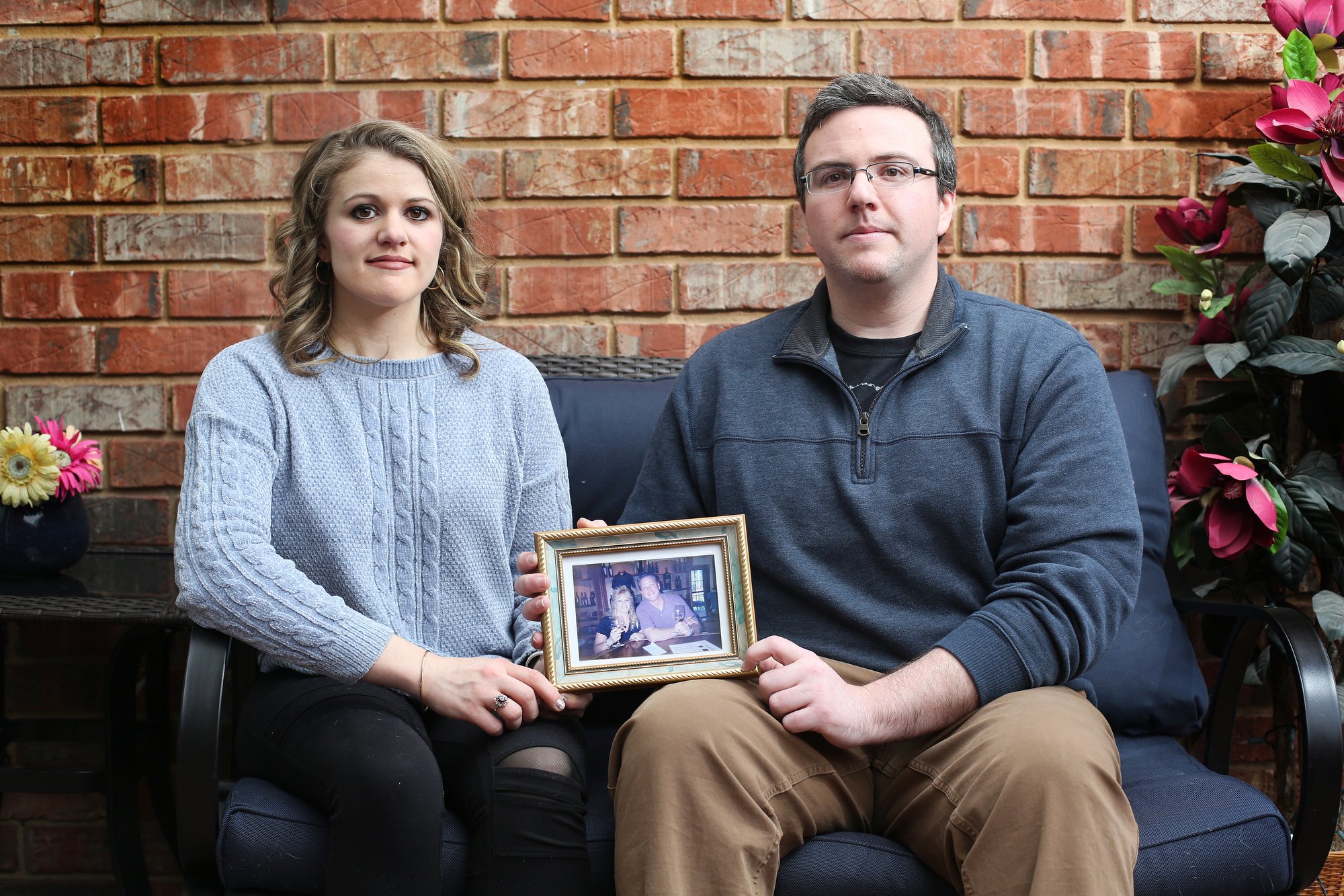 Siblings, Alaina Marinello and Christopher Marinello are photographed with a photo of their mom and dad, Lynda and Chris Marinello, Sunday, February 3, 2019 at Alaina's Chattanooga, Tenn., home. Lynda was the passenger in a plane crash in Soddy-Daisy, Tenn., earlier this year. Both Lynda and a family friend, Captain Frank W. Davey, who was the pilot, died in the crash.