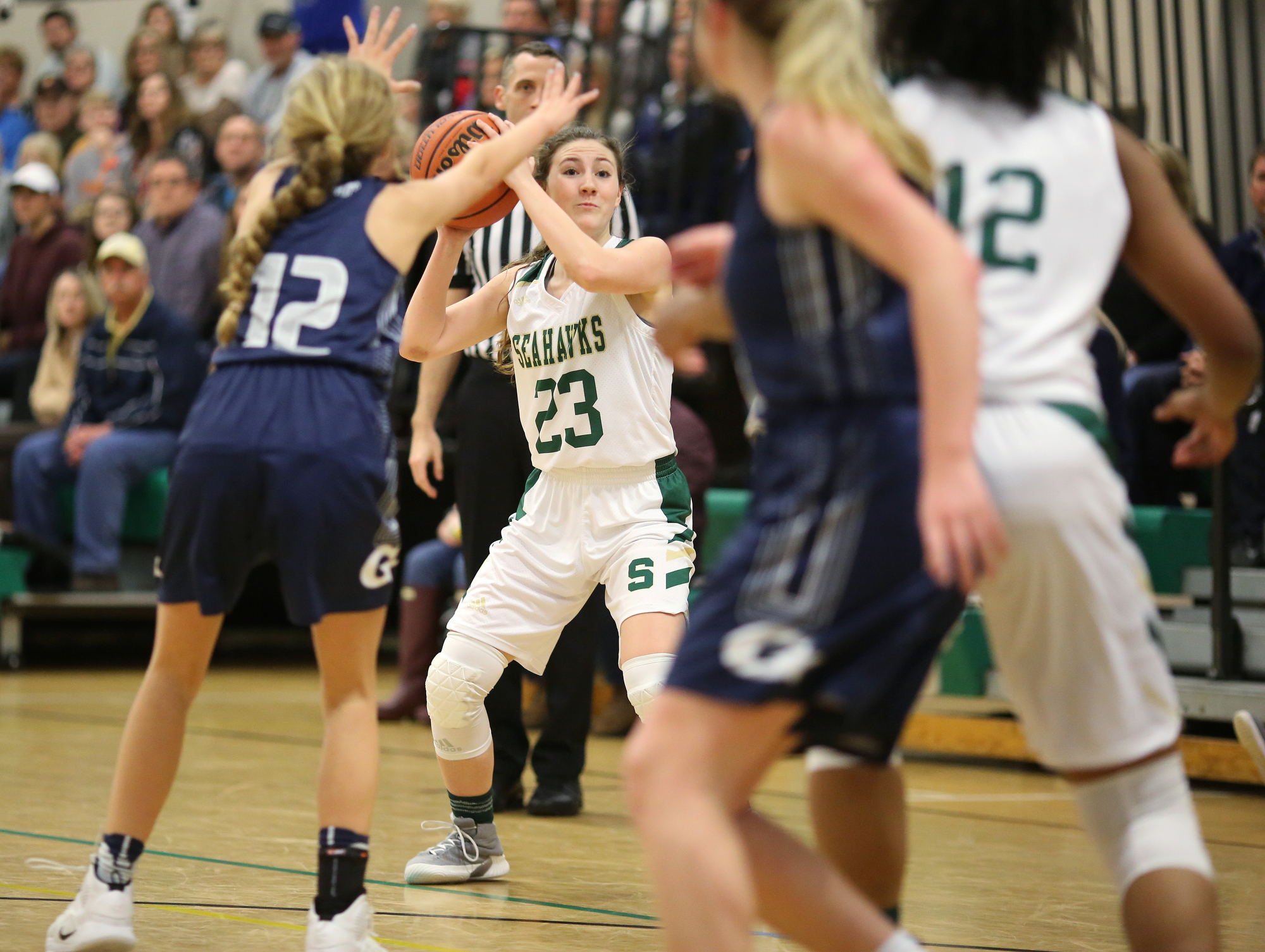 Silverdale's Tessa Gibson (23) looks to pass the ball while being guarded by Grace Christian Academy's Baylee Stewart (12) during the Silverdale vs. Grace Christian Academy region tournament game Tuesday, February 12, 2019 at Silverdale Baptist Academy in Chattanooga, Tennessee.