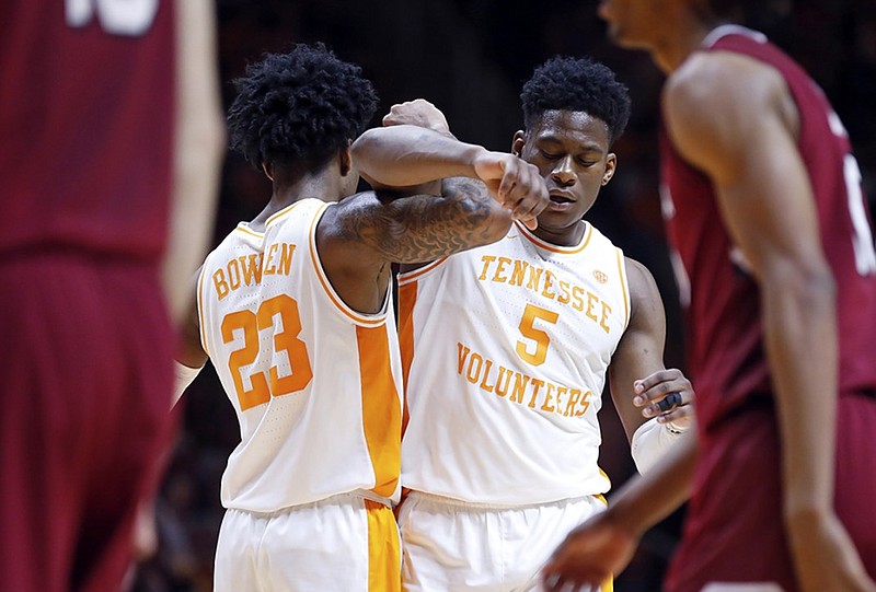 Tennessee's Admiral Schofield (5) is congratulated by teammate Jordan Bowden (23) after being fouled during the second half of Wednesday night's game in Knoxville. Top-ranked Tennessee won 85-73 to extend its program-record winning streak to 19 games.