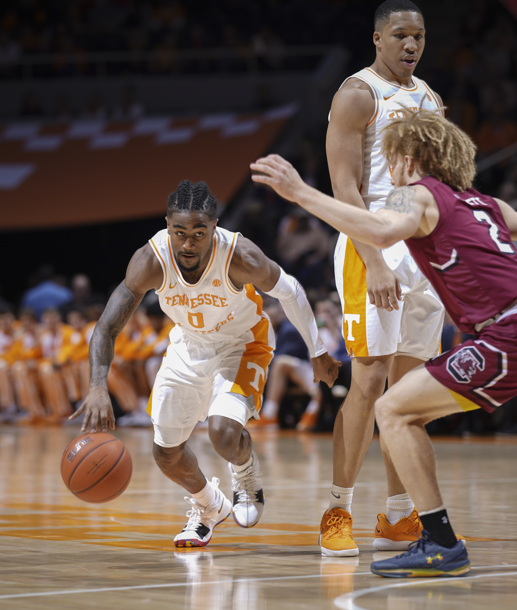 Tennessee's Jordan Bone drives as teammate Grant Williams sets a screen against South Carolina's Hassani Gravett during Wednesday night's game at Thompson-Boling Arena in Knoxville.