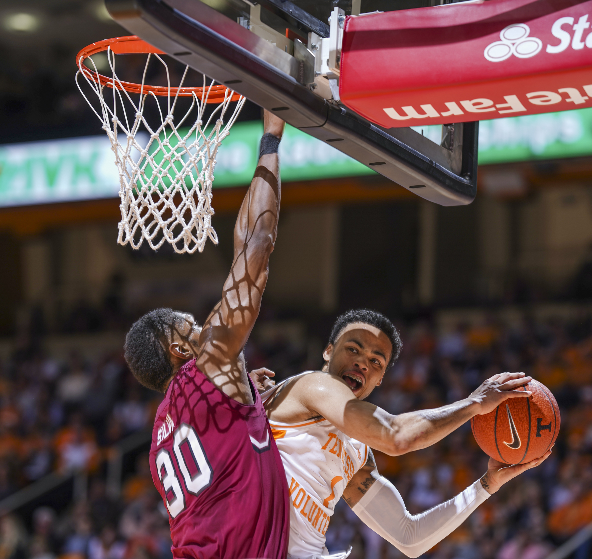 Tennessee's Lamonte Turner tries to pass under the basket and around South Carolina's Chris Silva on Wednesday night at Thompson-Boling Arena in Knoxville.