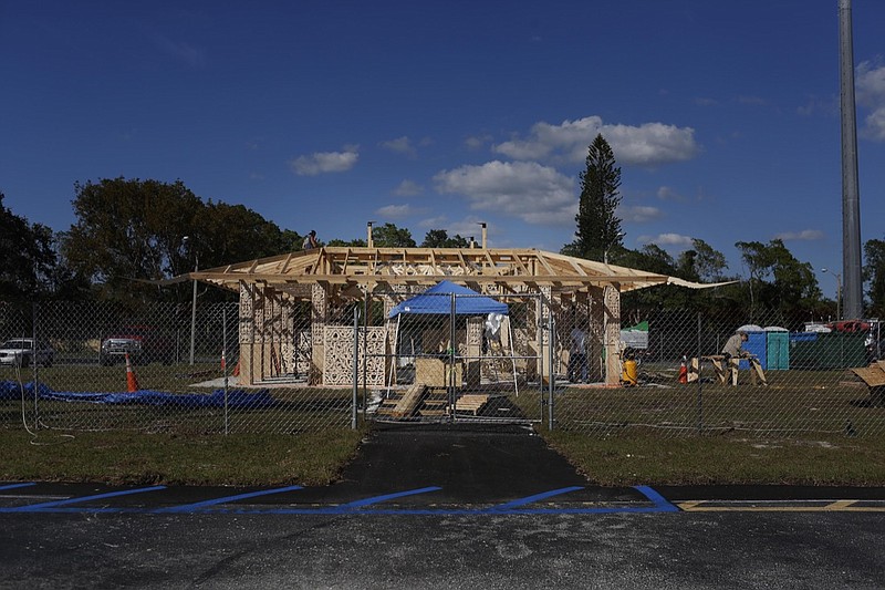 California artist David Best, and a team of volunteers build a non-denominational, temporary temple for the anniversary of the Marjory Stoneman Douglas High School shooting massacre, on Tuesday, Feb. 5, 2019 in Coral Springs, Fla. Visitors will be allowed to mourn, remember, contemplate, leave mementos and write message on its walls. (AP Photo/Brynn Anderson)