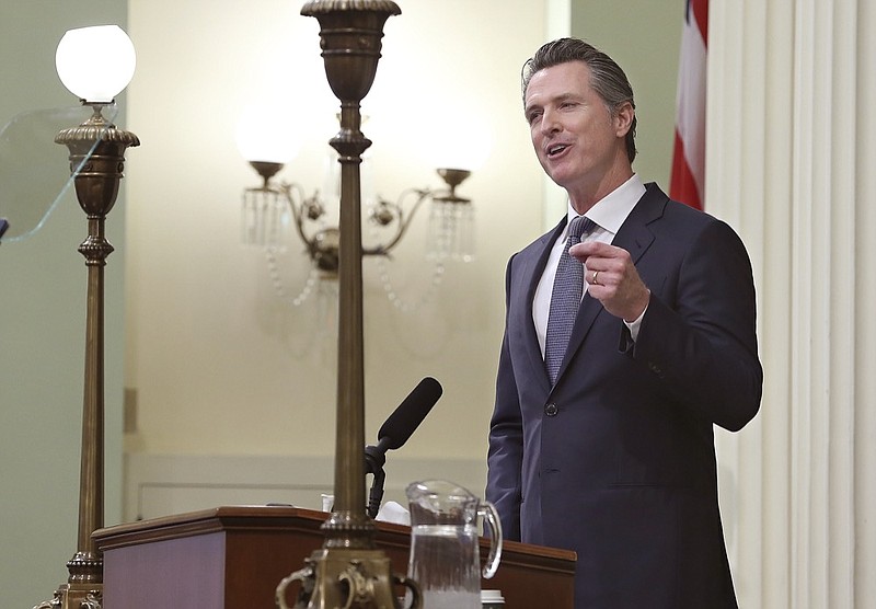 In this photo taken Tuesday, Feb. 12, 2019, California Gov. Gavin Newsom delivers his first state of the state address to a joint session of the legislature at the Capitol in Sacramento, Calif. Newsom said the state's consumers should get a "data dividend" from technology companies, like Google and Facebook, who are make by capitalizing on the personal data they collect. (AP Photo/Rich Pedroncelli)

