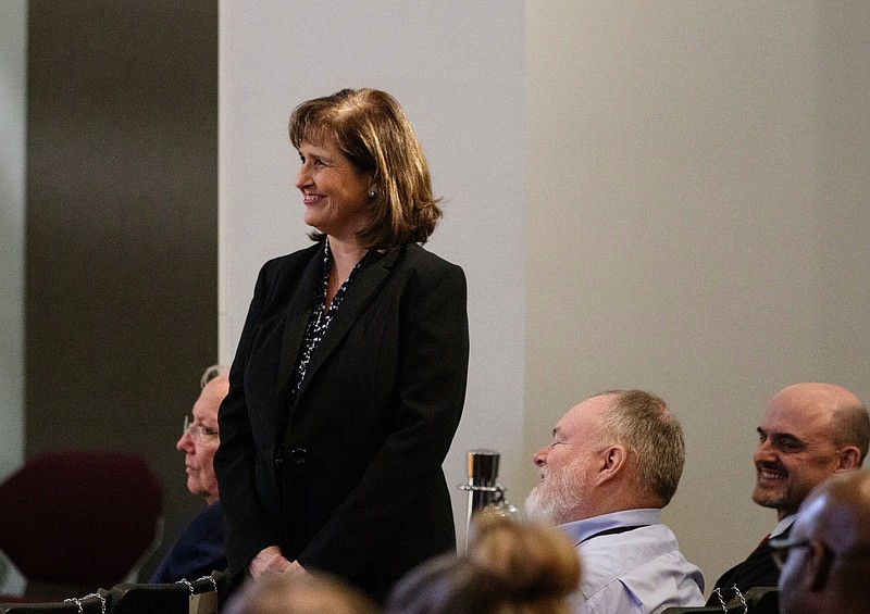 TVA engineer of the year Marjorie Parsons stands during a meeting by the Tennessee Valley Authority's board of directors at TVA Headquarters on Thursday, Feb. 14, 2019, in Chattanooga, Tenn. During the meeting, the board voted 6-1 to close the Paradise and Bull Run coal power plants, citing the plants' inefficiency, age and obsolescence in the current TVA power system.