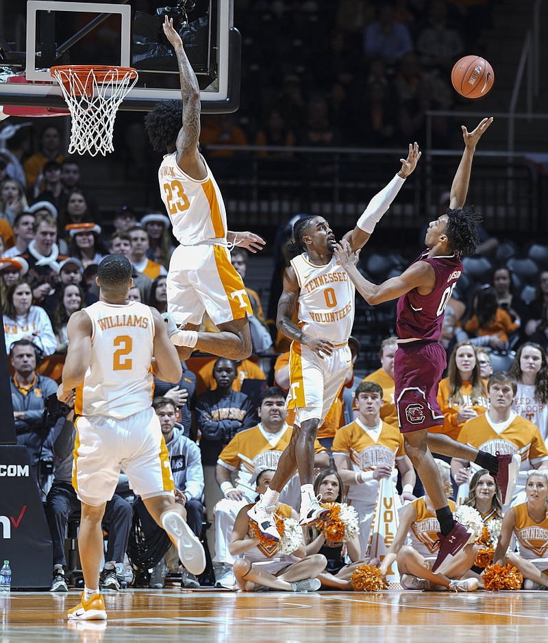 Tennessee's Jordan Bowden (23) and Jordan Bone (0) get in South Carolina's A.J. Lawson face as he shoots during Wednesday night's game in Knoxville. Tennessee won 85-73, its 19th straight victory.