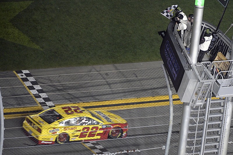 Joey Logano takes the checkered flag to win the second of two 150-mile qualifying races Thursday night for Sunday's season-opening Daytona 500.