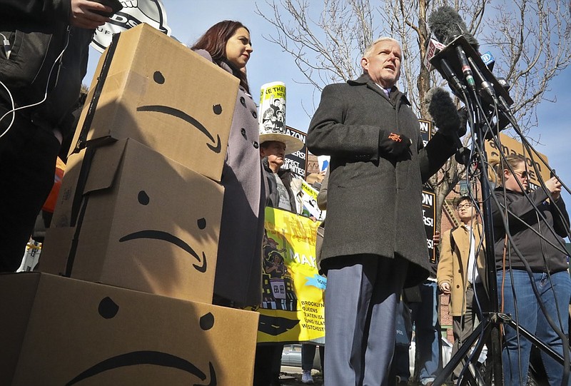 New York City Councilman Jimmy Van Bramer, center, speaks during a conference in Gordon Triangle Park in the Queens borough of New York, following Amazon's announcement it would abandon its proposed headquarters for the area, Thursday Feb. 14, 2019. (AP Photo/Bebeto Matthews)

