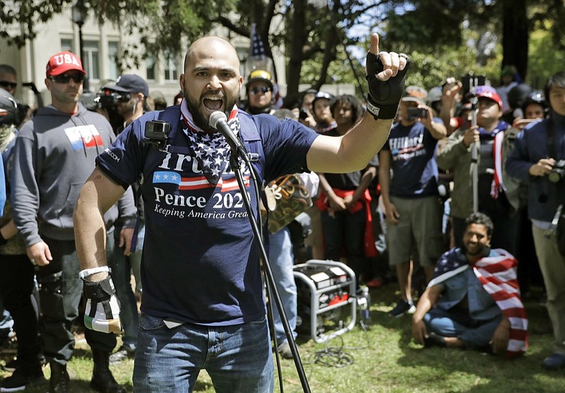 FILE - In this April 27, 2017, file photo, Joey Gibson speaks during a rally in support of free speech in Berkeley, Calif. The mayor of Portland, Oregon, has asked the police chief to investigate "disturbing" texts between the commander of the department's rapid response team and Gibson the leader of a far-right group involved in violent protests in the city. (AP Photo/Marcio Jose Sanchez, File)

