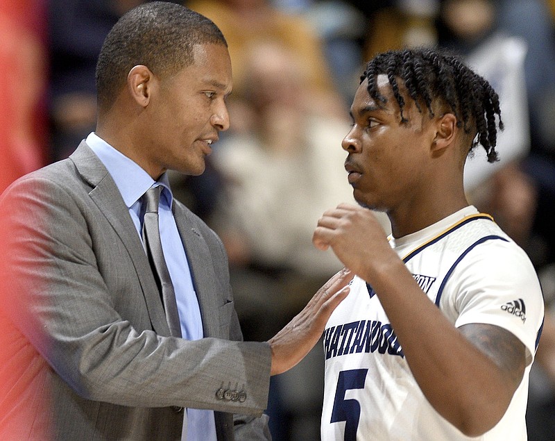 UTC men's basketball coach Lamont Paris talks to freshman guard Donovann Toatley during the Mocs' 80-75 against Samford on Jan. 12 at McKenzie Arena.