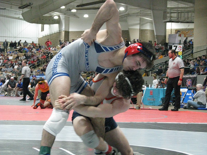 Cleveland 145-pounder Grant Lundy, left, takes on Summitt's Cole Klingensmith in the TSSAA Class AAA traditional state semifinals at the Williamson County Ag Expo Park in Franklin on Friday.