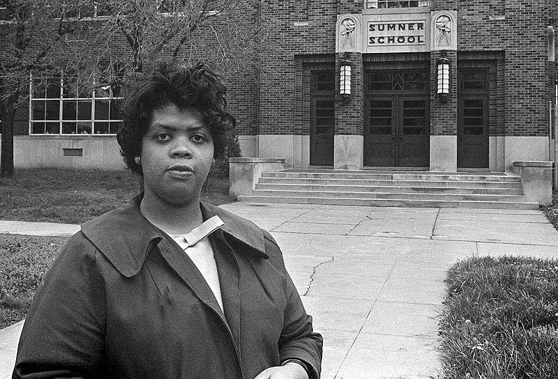 Linda Brown stands in front of Sumner School in Topeka, Kansas, in this May 8, 1964, file photo. The refusal of the school to admit Brown, then 9 years old, in 1951, led to the Brown vs. The Board of Education of Topeka lawsuit in which the U.S. Supreme Court mandated that schools nationwide must be desegregated.