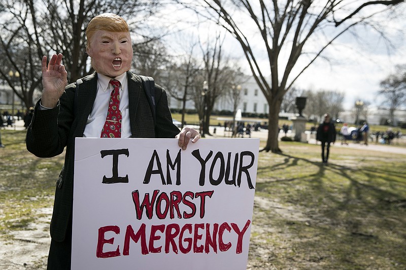 A demonstrator impersonates President Donald Trump during a protest against his emergency declaration in Lafayette Square, across the street from the White House, on Monday. (Sarah Silbiger/The New York Times)