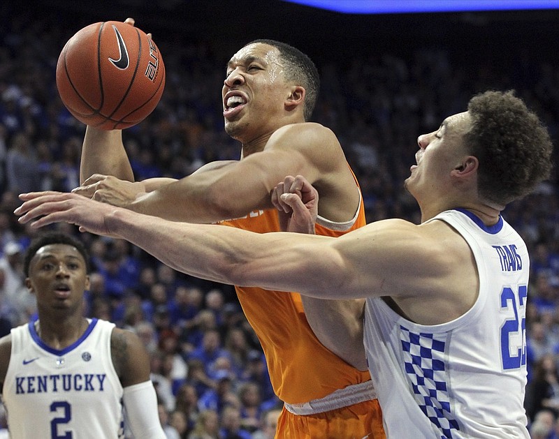 Tennessee's Grant Williams, left, shoots while pressured by Kentucky's Reid Travis during the second half of an NCAA college basketball game in Lexington, Ky., Saturday, Feb. 16, 2019. Kentucky won 86-69. (AP Photo/James Crisp)