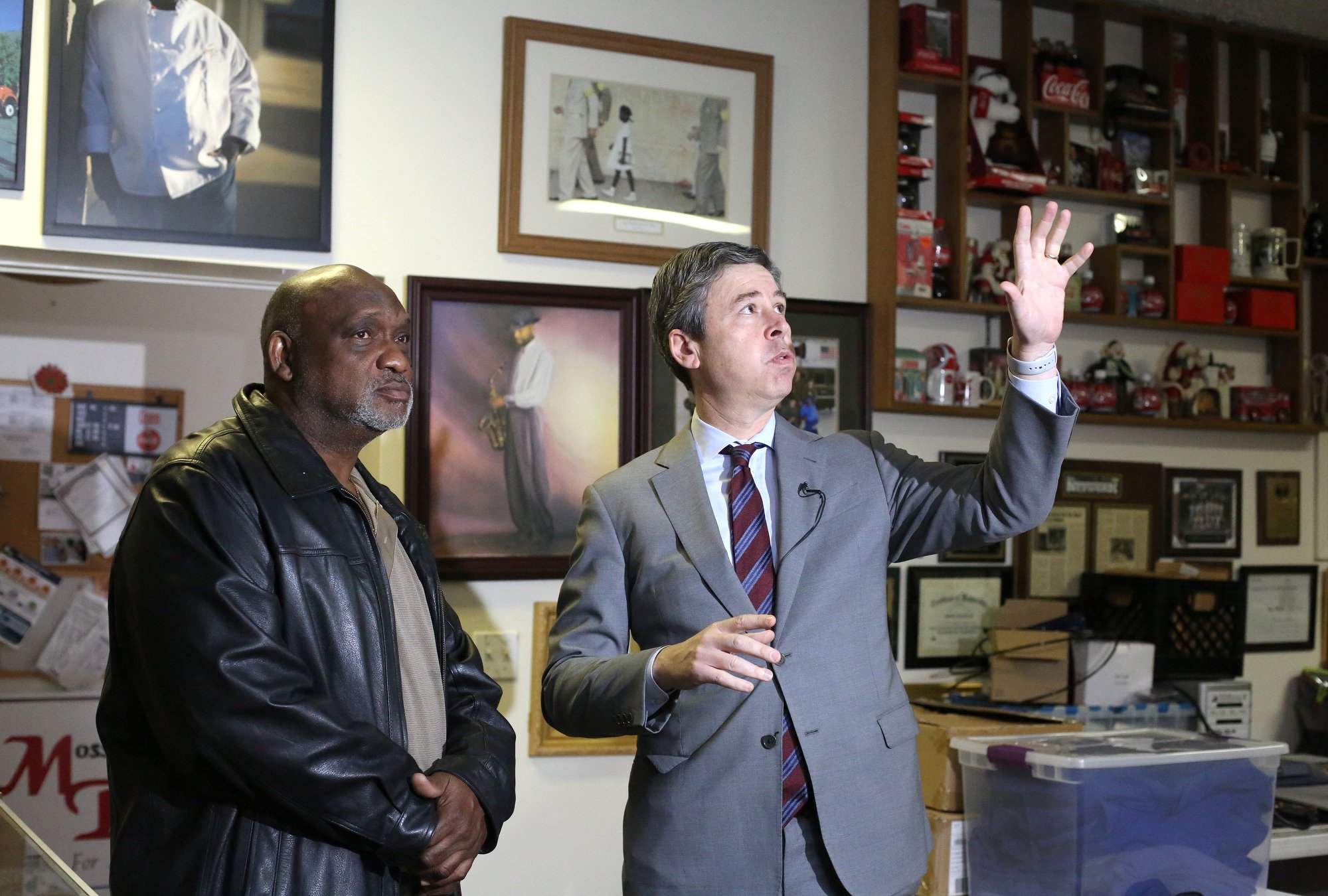Darnell Moss, the owner of Moss' Place Catering, stands alongside Chattanooga Mayor Andy Berke as Berke talks about the fixes to the roof that Moss has talked about needing. Berke held a press conference at Moss' Place Catering Monday, February 18, 2019 in Chattanooga, Tennessee, to talk about a proposed new loan initiative aimed to help small businesses.