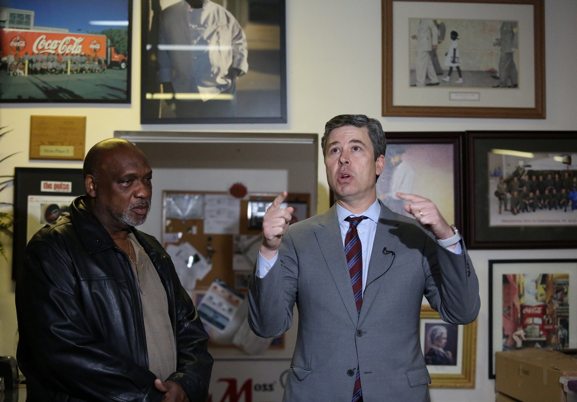 Darnell Moss, the owner of Moss' Place Catering, stands alongside Chattanooga Mayor Andy Berke as Berke talks about the fixes to the roof that Moss has talked about needing. Berke held a press conference at Moss' Place Catering Monday, February 18, 2019 in Chattanooga, Tennessee, to talk about a proposed new loan initiative aimed to help small businesses.