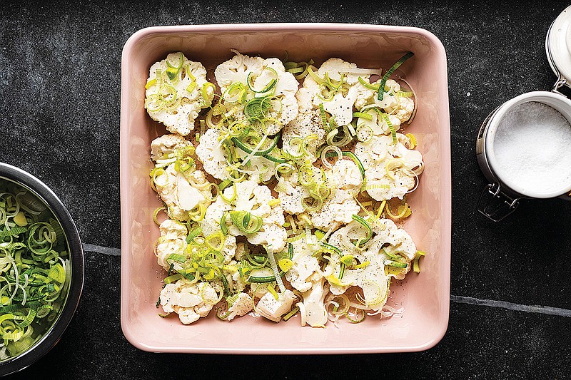 Preparation of cauliflower gratin with leeks and white cheddar is shown in New York, Nov. 2, 2018. Prized for its chameleon-like nature, cauliflower is able to become nearly anything, and is just as exciting as anything loaded with chlorophyll. (Karsten Moran/The New York Times)