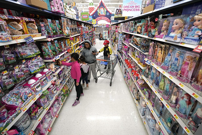 FILE- In this Nov. 9, 2018, file photo shoppers look at toys at a Walmart Supercenter in Houston. Walmart Inc. reports financial results Tuesday, Feb. 19, 2019. (AP Photo/David J. Phillip, File)