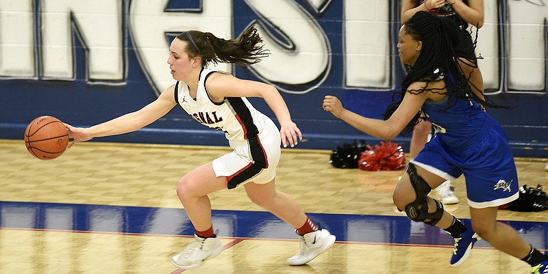 Signal's Jolie McGann (21) pulls in a loose ball as Red Bank's Lanaja Bowens (25) pursues.  The Red Bank Lady Lions met the Signal Mountain Lady Eagles for the District 6-AA girls' basketball tournament championship at Red Bank High School on February 19, 2019.  