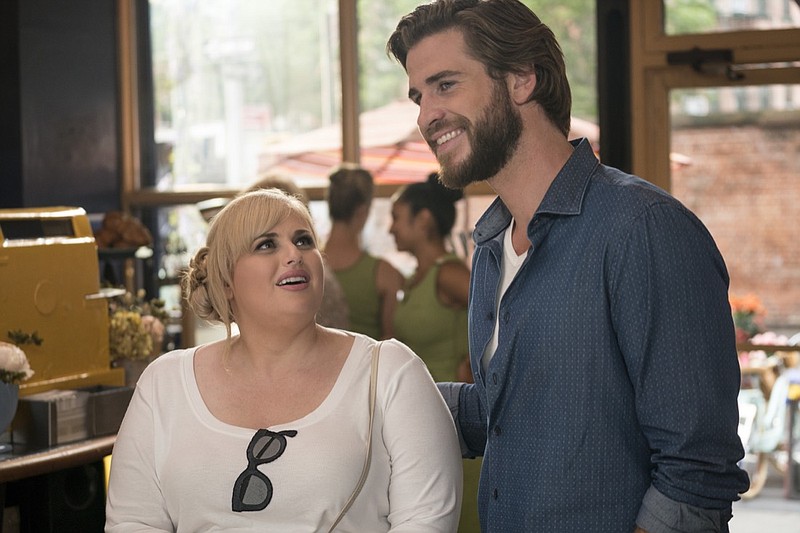 This image released by Warner Bros. Pictures shows Rebel Wilson, left, and Liam Hemsworth in a scene from "Isn't It Romantic." (Michael Parmelee/Warner Bros. Pictures via AP)