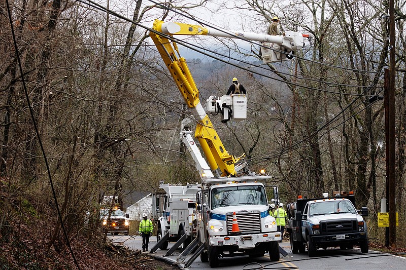 EPB repairs power lines after a fallen tree closed Gadd Road on Wednesday, Feb. 20, 2019, in Chattanooga, Tenn. Continuous rain through the week has raised area waterways to flood stages, with more rain expected in the coming days.