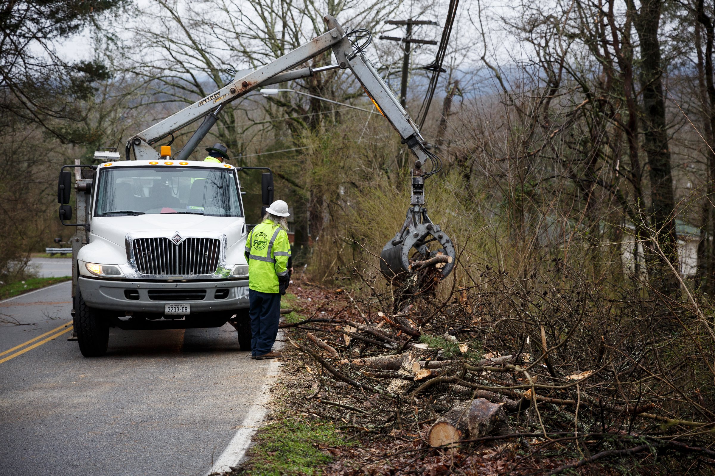 Chattanooga Public Works clears debris after a fallen tree closed Gadd Road on Wednesday, Feb. 20, 2019, in Chattanooga, Tenn. Continuous rain through the week has raised area waterways to flood stages, with more rain expected in the coming days.