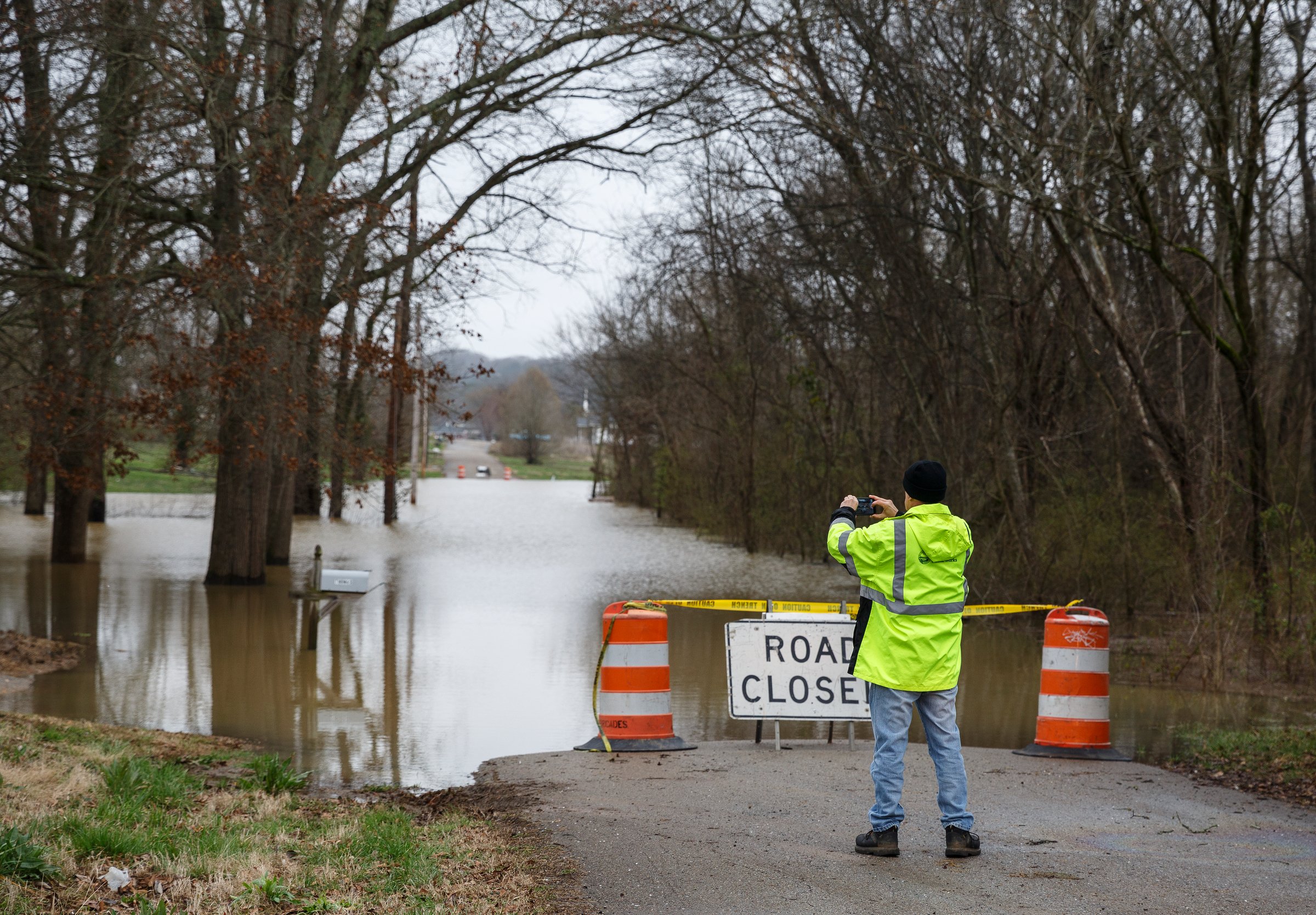 Kenny Kinnaman with Chattanooga Public Works photographs floodwaters covering Aster Road in Lookout Valley after heavy rainfall on Wednesday, Feb. 20, 2019, in Chattanooga, Tenn. Continuous rain through the week has raised area waterways to flood stages, with more rain expected in the coming days.