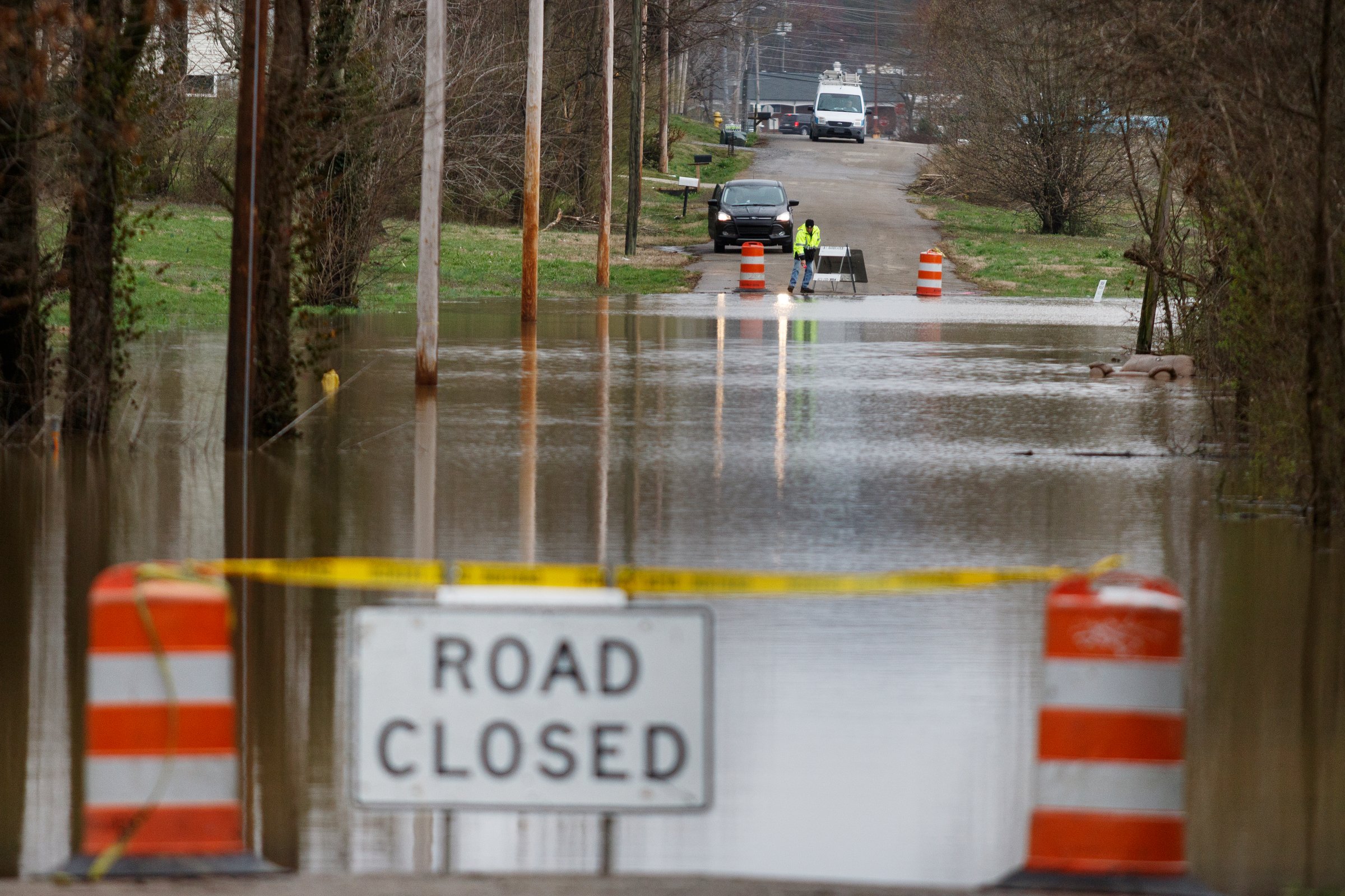 Kenny Kinnaman with Chattanooga Public Works surveys floodwaters covering Aster Road in Lookout Valley after heavy rainfall on Wednesday, Feb. 20, 2019, in Chattanooga, Tenn. Continuous rain through the week has raised area waterways to flood stages, with more rain expected in the coming days.