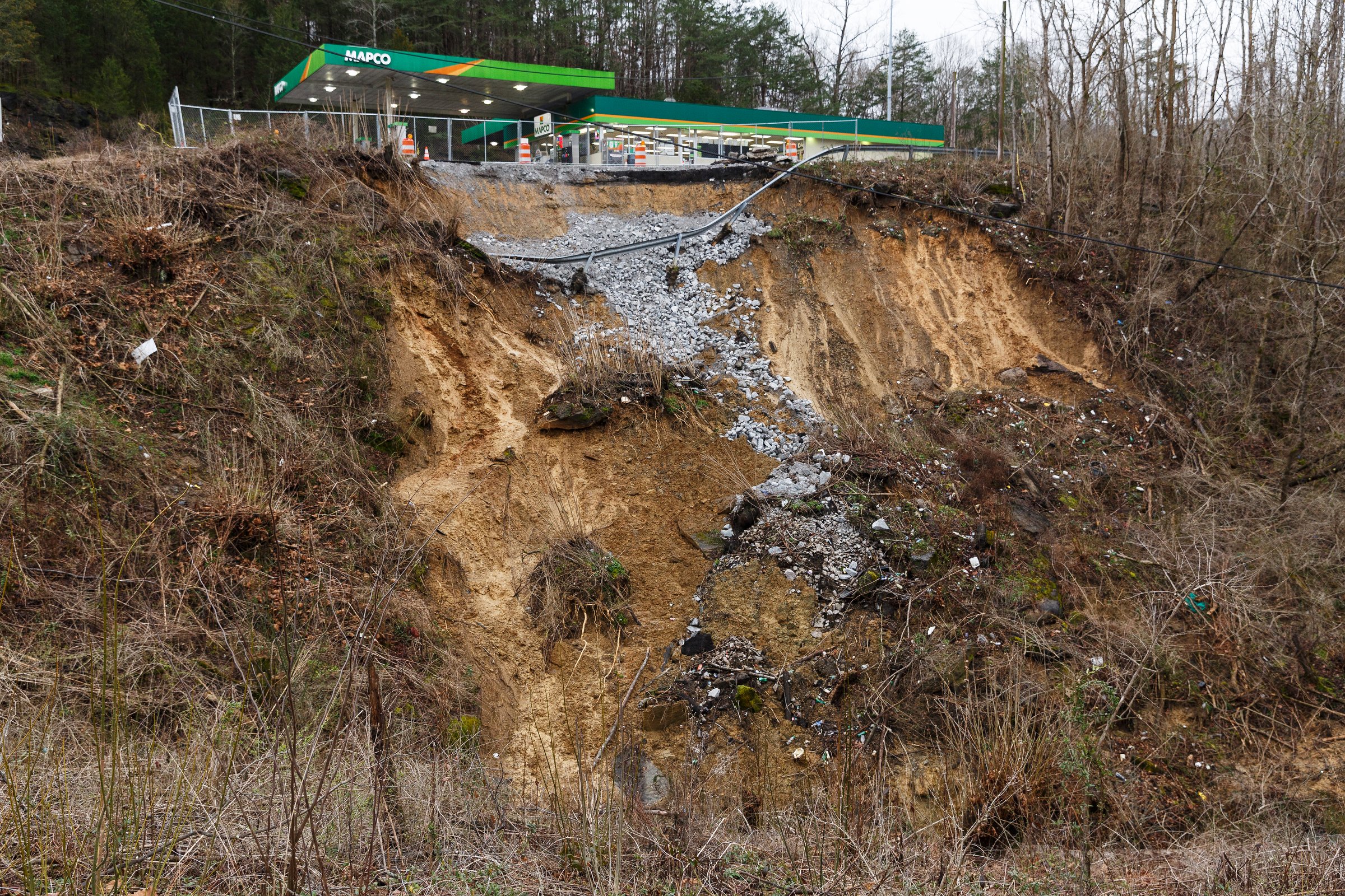 A section of hillside beneath a Mapco gas station slid away after heavy rainfall, seen on Wednesday, Feb. 20, 2019, in Wildwood, Ga. Continuous rain through the week has raised area waterways to flood stages, with more rain expected in the coming days.