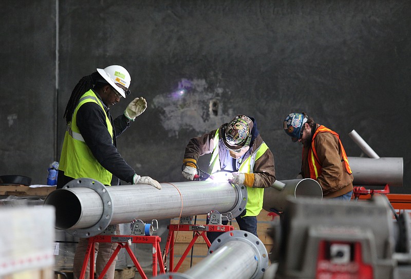 Construction workers weld a pipe Wednesday, February 20, 2019 at the Nokian Tyres plant under construction in Dayton, Tennessee. About 200 construction workers are on site each day.