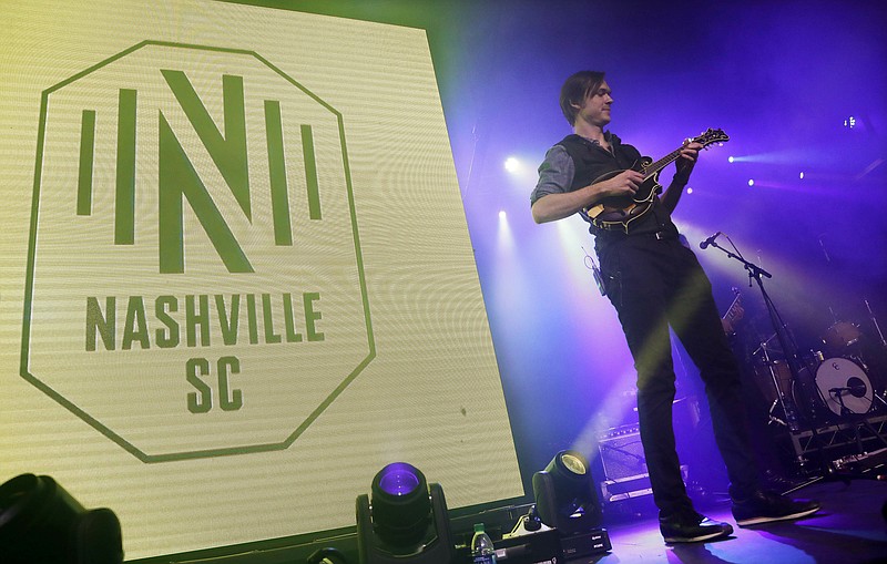 A band performs as the logo of the Nashville Soccer Club is displayed at the unveiling of the MLS team's name, logo and colors on Wednesday in Nashville. The expansion franchise is set to start competing in the league in 2020.