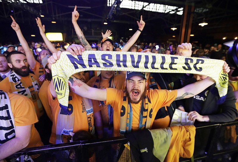 AP photo by Mark Humphrey / Nashville SC fans celebrate during the official unveiling of the MLS expansion team's name, logo and colors on Nov. 20, 2019.