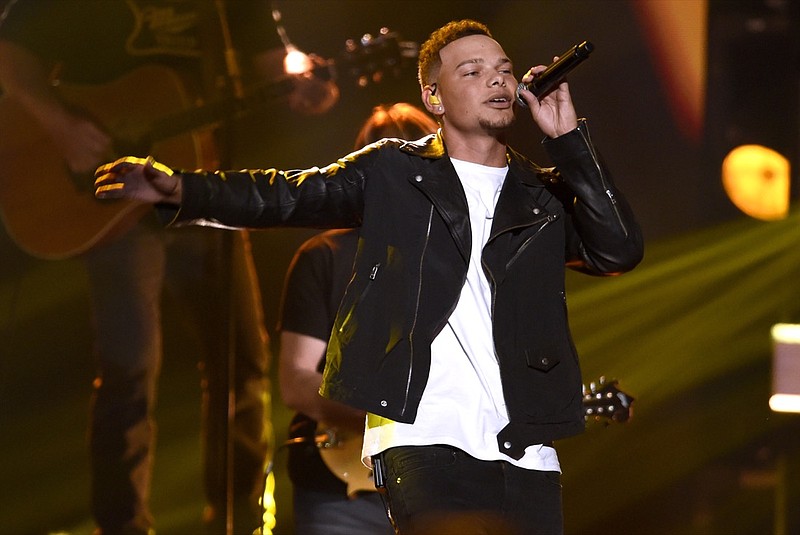FILE - In this Nov. 8, 2017 file photo, Kane Brown performs "Heaven South" at the 51st annual CMA Awards at the Bridgestone Arena in Nashville, Tenn. Country singers Brown and Darius Rucker are sharing a chart record as the first two solo acts who are also minorities to follow each other with No. 1 country songs in the 28-year history of the Billboard Country Airplay chart. (Photo by Chris Pizzello/Invision/AP, File)