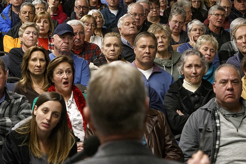 People look on as North Hamilton County United for Responsible Growth President Dean Moorhouse, center, speaks during a meeting at the Highway 58 Volunteer Fire Department Bob Scott Training Center on Monday, Dec. 10, 2018 in Ooltewah, Tenn.