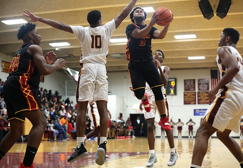 Howard's Marquez Williams (3) puts up a shot while being guarded by Tyner's Soloman Bridgeman (10) during the Tyner vs. Howard boys basketball game at Tyner Academy Friday, December 4, 2019 in Chattanooga, Tennessee.