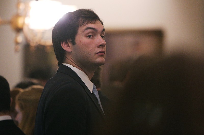 Staff photo by Erin O. Smith / Colton Moore, 24, looks back and forth between the three doors that serve as exits for the floor of the House of Representatives waiting for State Rep. John Deffenbaugh, R-Lookout Mountain, to exit during a dinner break Thursday, March 29, 2018 at the Georgia State Capitol in Atlanta, Ga. Moore will be running against Deffenbaugh in the upcoming race for District 1 and was invited by Deffenbaugh to the Capitol to shadow for a couple of days to learn what the job entails.