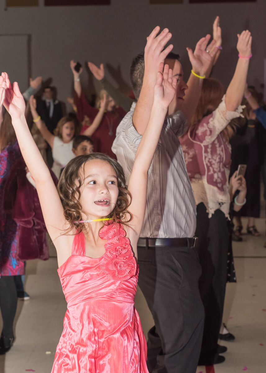 Small Tall Ball attendees throw their hands up and dance at Ooltewah Elementary's Small Tall Ball. The event had 450 in attendance, all of whom were Ooltewah Elementary School students and parents. / Contributed photo by Kat Marcum