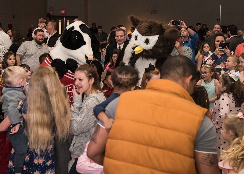 The Chick-fil-A cow and Hootie, mascot for the Ooltewah Elementary School Owls, participate in a dance-off at Ooltewah Elementary's Small Tall Ball / Contributed photo by Kat Marcum