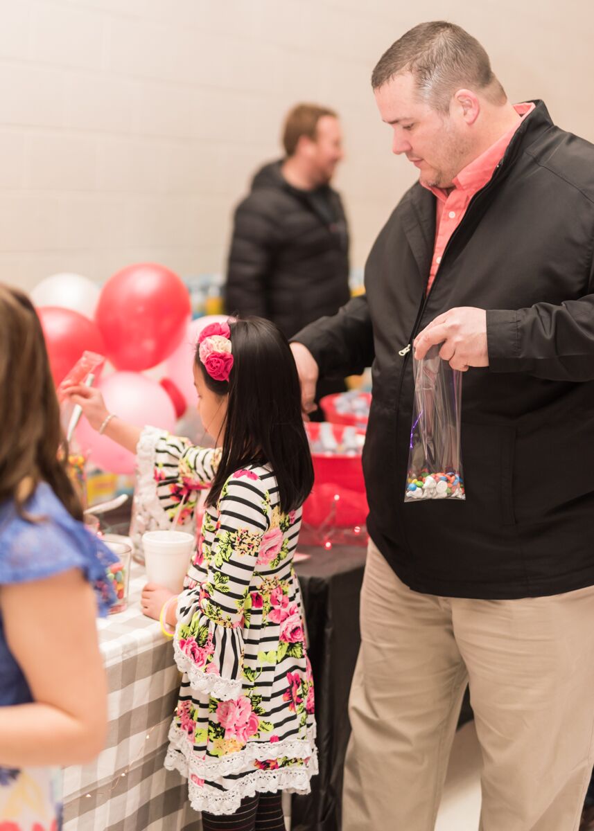 A father and daughter gather sweet treats from the candy bar at Ooltewah Elementary's Small Tall Ball. / Contributed photo by Kat Marcum