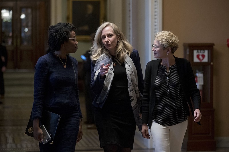 From left, Rep., Lauren Underwood, D-Illinois, Rep. Abigail Spanberger, D-Virginaa., and Rep. Chrissy Houlahan, D-Pennsylvania, walk out of the Senate Chamber following two failed Senate votes on ending the partial government shutdown on Capitol Hill in Washington on Jan. 24, 2019. (AP Photo/Andrew Harnik)