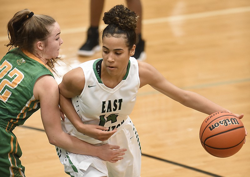 East Hamilton's Madison Hayes dribbles around Rhea County's Mallory Hampton during a Region 3-AAA tournament game Friday night. Hayes had 29 points, 18 rebounds, seven steals, six blocks and five assists as the host Lady Hurricanes won 56-49 to advance to a Monday semifinal against Stone Memorial at Bradley Central. Hampton led the Lady Eagles with 18 points.