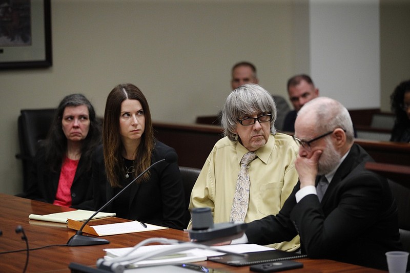 David Turpin, second from right, and wife, Louise, far left, listen to their charges as they are joined by their attorneys, Allison Lowe, second from left, and David Macher during a courtroom hearing, Friday, Feb. 22, 2019, in Riverside, Calif. The California couple who shackled some of their 13 children to beds and starved them pleaded guilty Friday to torture and other abuse in a case dubbed a "house of horrors." (AP Photo/Jae C. Hong, Pool)