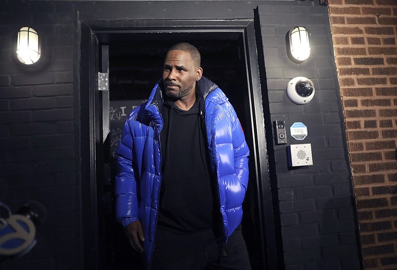 Musician R. Kelly emerges from his Chicago studio Friday night, Feb. 22, 2019. R&B star R. Kelly arrived Friday night at a Chicago police precinct, hours after authorities announced multiple charges of aggravated sexual abuse involving four victims, including at least three between the ages of 13 and 17. (Abel Uribe/Chicago Tribune via AP)

