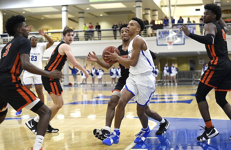 McCallie's Eric Rivers is surrounded by the Ensworth defense as he drives to the basket during Saturday night's TSSAA Division II-AA state quarterfinal at McCallie. Rivers, a sophomore, led the Blue Tornado with 20 points.