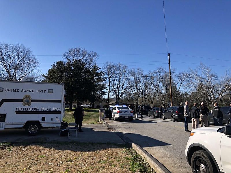 A heavy police presence sets up outside a home in the 200 block of Port Drive in Hixson. A vehicle parked in a driveway matches the description of one that hit and killed a Chattanooga police officer before fleeing the scene. 