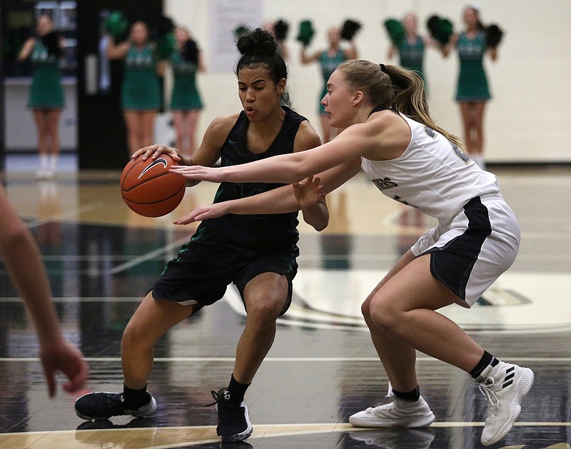 East Hamilton's Madison Hayes (14) dribbles the ball downcourt while being guarded by Stone Memorial's Tessa Miller (25) during the East Hamilton vs. Stone Memorial girls Region 3-AAA semifinal game at Bradley Central High School Monday, February 25, 2019 in Cleveland, Tennessee.