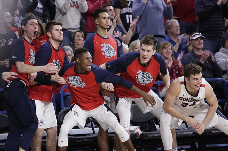 Players on the Gonzaga bench celebrate during the second half of an NCAA college basketball game against BYU in Spokane, Wash., Saturday, Feb. 23, 2019. Gonzaga won 102-68. (AP Photo/Young Kwak)
