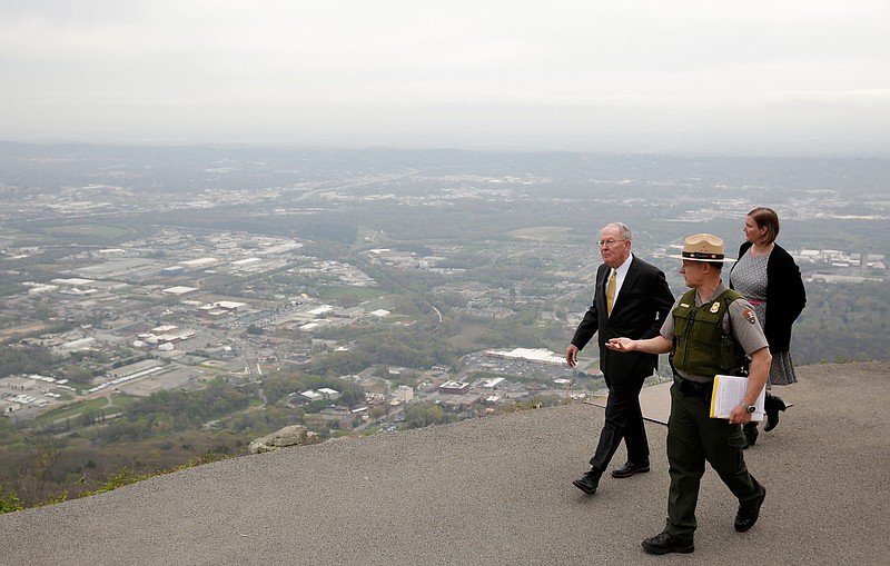 U.S. Sen. Lamar Alexander, left, looks into the Chattanooga valley as he walks with chief ranger Todd Roeder, center, and Tricia Mims with the Friends of Chickamauga and Chattanooga National Military Parks during a visit to Point Park on Tuesday, April 3, 2018, in Lookout Mountain, Tenn. Sen. Alexander visited the park to push for a bill that he says will help address maintenance backlogs at federal parks like Point Park.