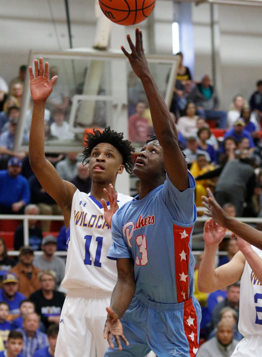 Brainerd's Trey Owten (3) shoots ahead of Sweetwater's Dominique Oggs during the Panthers' Region 3-AA basketball tournament semifinal game against Sweetwater at Loudon High School on Tuesday, Feb. 26, 2019, in Loudon, Tenn.