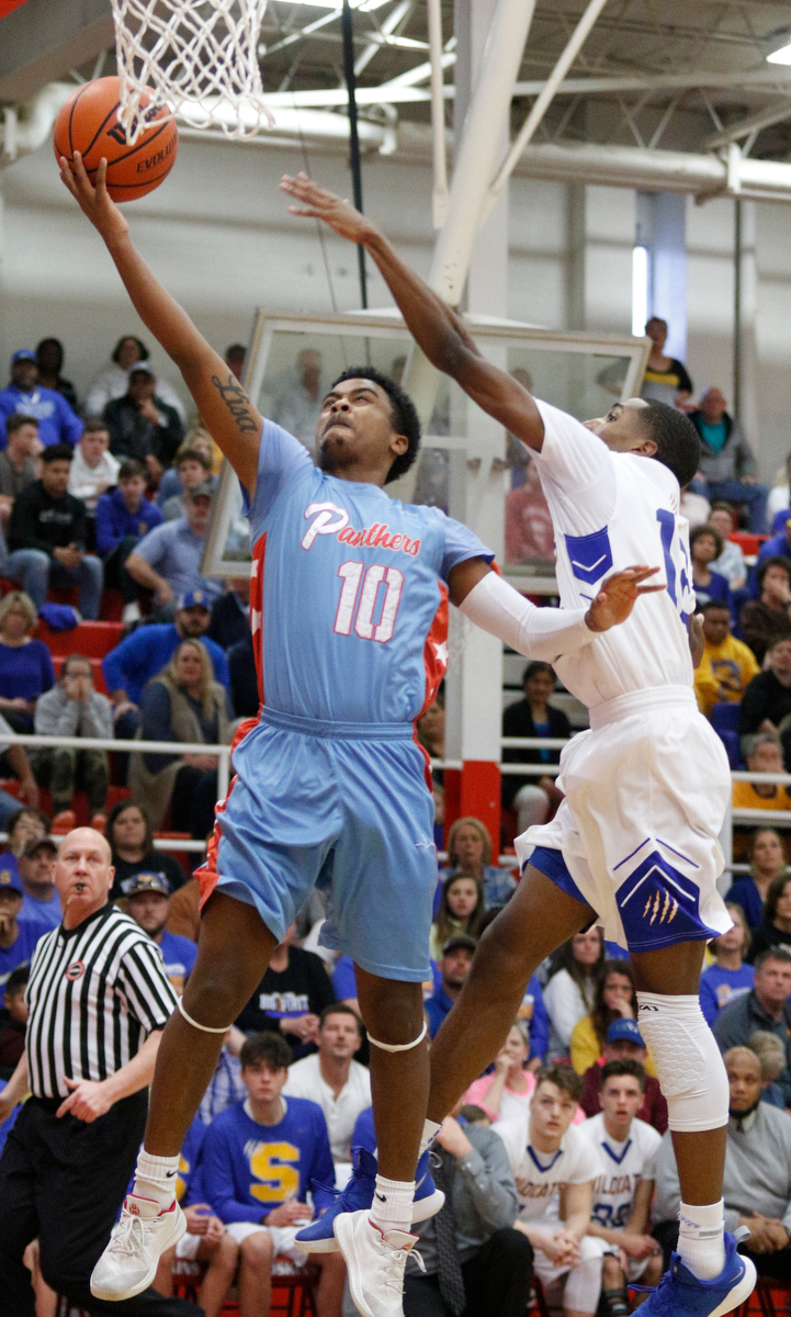 Brainerd's Kevin Halfacre Jr. shoots ahead of Sweetwater's Kolbe Billingsley during the Panthers' Region 3-AA basketball tournament semifinal game against Sweetwater at Loudon High School on Tuesday, Feb. 26, 2019, in Loudon, Tenn.