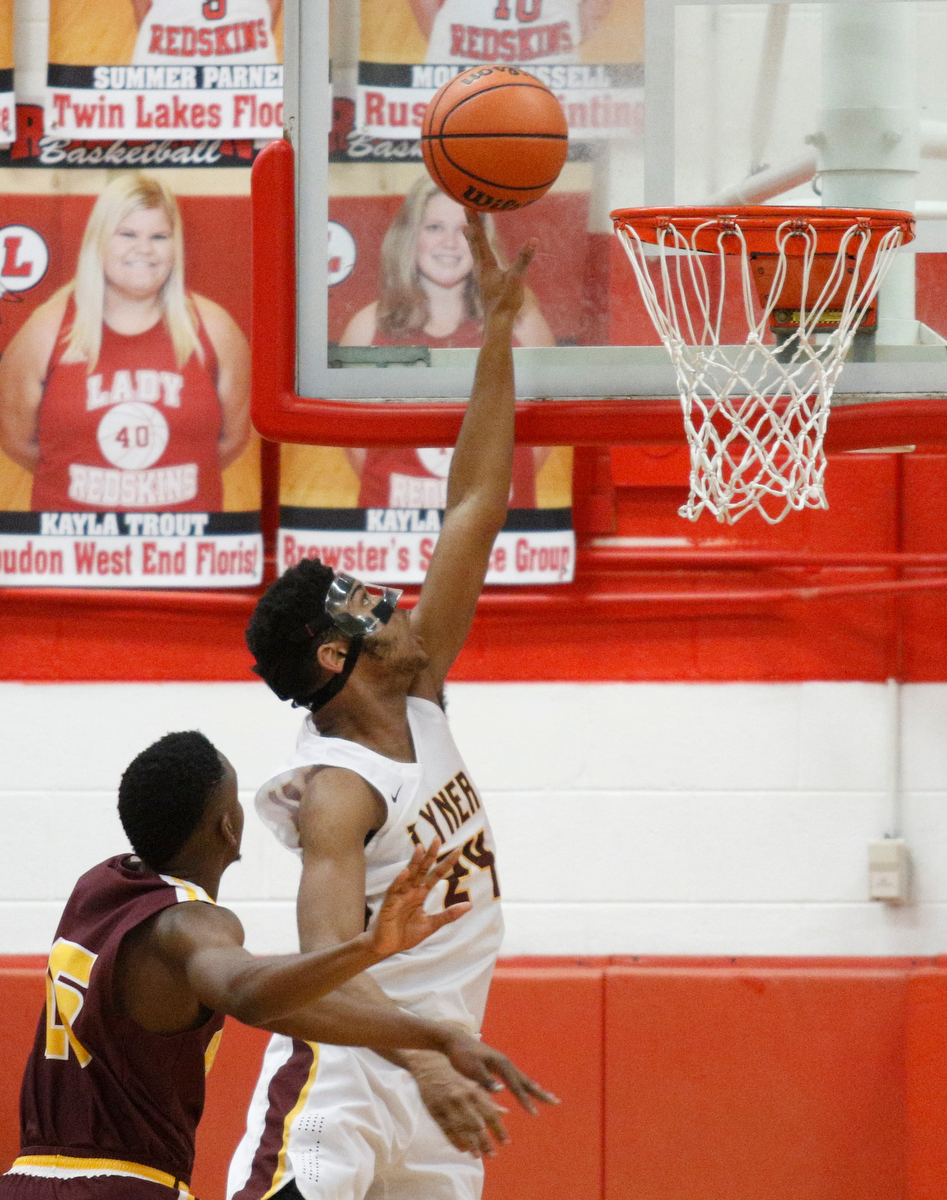 Tyner's Kobe Smith shoots ahead of Howard's Reuben Snow during their Region 3-AA basketball tournament semifinal game at Loudon High School on Tuesday, Feb. 26, 2019, in Loudon, Tenn. Brainerd won 70-65.